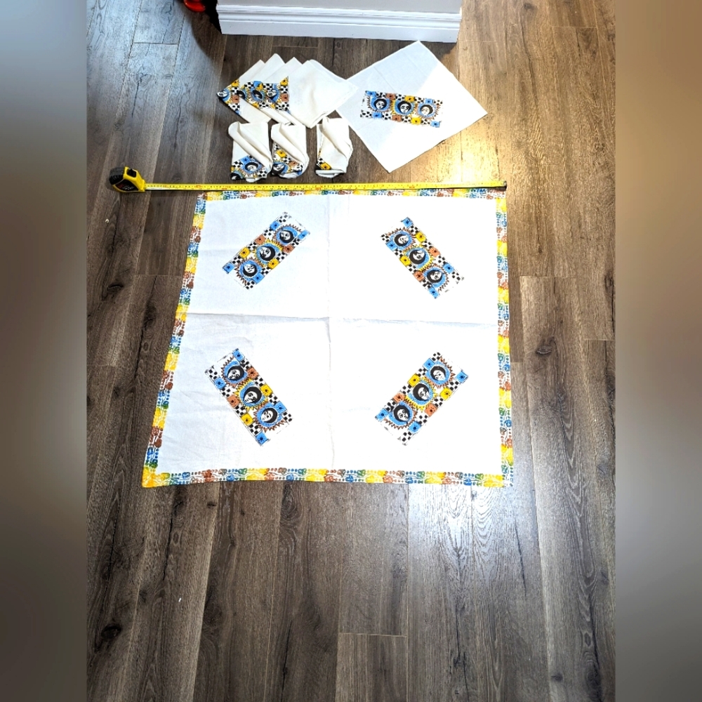 Small table cloth and 8 Napkins.  Cotton with art work . Excellent condi…